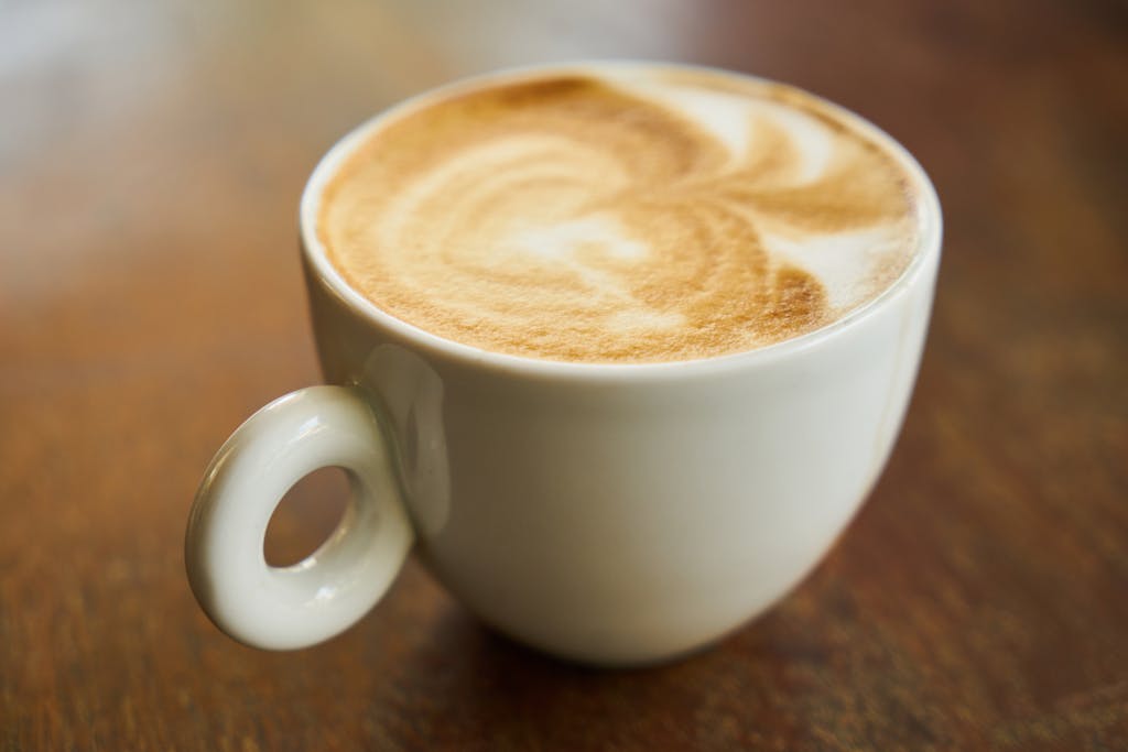 Filled Cup on Brown Wooden Surface